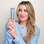 Woman holding Face Reality Sulfur Spot Treatment – 6% sulfur fast-acting acne spot treatment for targeted breakout control