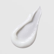 Face Reality HydraCalm Mask texture swatch – smooth glossy white cream formula on light gray background