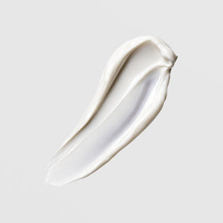 Face Reality Mineral Matte SPF 28 texture swatch – smooth white mineral sunscreen cream on gray background