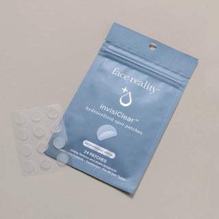 Face Reality InvisiClear Hydrocolloid Spot Patches blue resealable pouch beside sheet of 24 translucent acne patches for all skin types