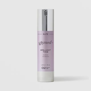GlyMed Plus Elite Brilliant Tone serum in white pump bottle with silver pump and lavender label, 1.69 oz, on light gray background