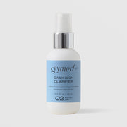 GlyMed Plus Daily Skin Clarifier in white pump bottle with silver collar and light blue label, 2.0 oz, on light gray background