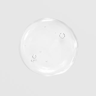 GlyMed Plus Accelerator Gel with 20% Alpha Hydroxy Acids texture swatch showing clear, lightweight gel consistency with air bubbles on light gray background