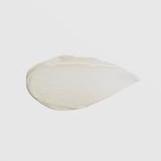 GlyMed Plus Age Delay Cream teardrop-shaped opaque white cream texture swatch showing smooth dense consistency on grey background