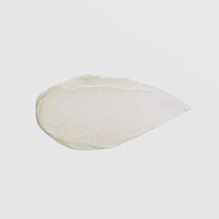 GlyMed Plus Age Delay Cream teardrop-shaped opaque white cream texture swatch showing smooth dense consistency on grey background