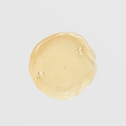 GlyMed Plus Elite Brilliant Tone texture swatch showing lightweight golden gel consistency with air bubbles on light gray background