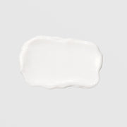 GlyMed Plus Elite Protective Skin Serum with Ceramides texture swatch showing smooth, glossy white cream consistency on light gray background