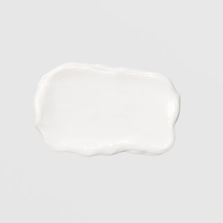 GlyMed Plus Elite Protective Skin Serum with Ceramides texture swatch showing smooth, glossy white cream consistency on light gray background
