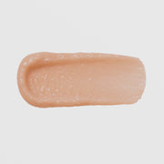 Close-up swatch of GlyMed Plus Rejuvenating Peptide Masque showing a thick, creamy peach-toned texture on a light gray background