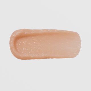 Close-up swatch of GlyMed Plus Rejuvenating Peptide Masque showing a thick, creamy peach-toned texture on a light gray background