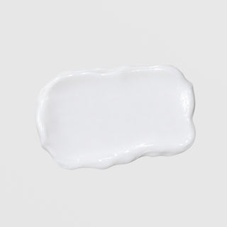 Close-up texture swatch of GlyMed Plus Vitamin E Cream showing rich white cream formula