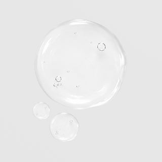 GlyMed Plus Acne Astringent No. 2 with Salicylic Acid texture swatch showing clear, water-like liquid consistency with air bubbles on light gray background