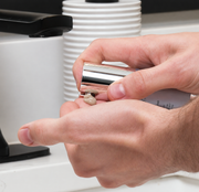 man Dispensing GlyMed Plus CBD Soothing Serum with Micro-Silver from silver pump applicator onto fingertip

