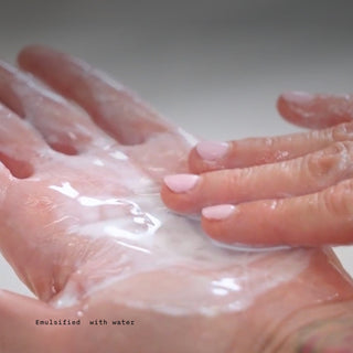 GlyMed Plus Illuminating Cleansing Oil emulsifying into a milky lather with water on hands