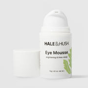 Hale & Hush Eye Mousse brightening and lines rehab eye cream in a white airless pump bottle with cap removed and green leaf botanical design, 12g / 0.42 oz, on a light gray background