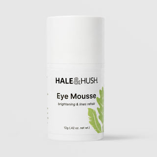 Hale & Hush Eye Mousse 12g airless pump bottle with cap on, green botanical feather and leaf graphics, labeled brightening and lines rehab