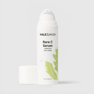 Hale & Hush Rare C Serum radiance and pore rehab vitamin C serum in a white airless pump bottle with cap removed and green leaf botanical design, 50ml / 1.69 fl oz, on a light gray background