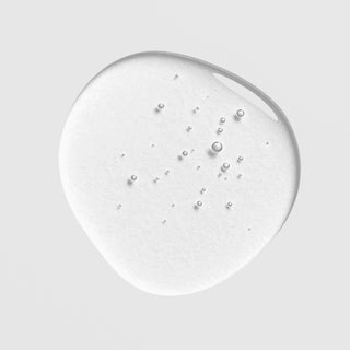 Close-up of Hale & Hush Rare C Serum showing a lightweight clear serum with tiny bubbles on a light gray background