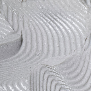 Macro closeup of Hale & Hush Charcoal Clarifying Mask showing smooth gray clay texture with charcoal flecks and swirled ridges