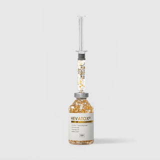 Hevatox Gold Lifting Ampoule vial with syringe applicator inserted showing 99.9% pure gold flakes, SP1-NPTox topical lifting protein, Theramogen ATC, and DERMA-CLERA by TOV Medical Aesthetics