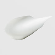 Hydrinity Eye Renew Complex texture swatch showing smooth silky white eye cream formula on grey background.