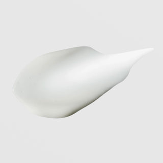 Hydrinity Eye Renew Complex texture swatch showing smooth silky white eye cream formula on grey background.