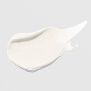 Hydrinity Hydri-C Daily Vitamin C Moisturizer texture swatch showing lightweight white cream formula on grey background.
