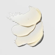 Hydrinity Luxe Lip Hydrator texture swatches showing layered translucent pale cream lip balm formula on grey background.