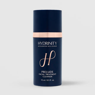 Hydrinity Prelude Facial Treatment Cleanser 15ml travel size in navy blue pump bottle with rose gold accent band and logo