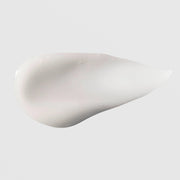 Hydrinity Renewing HA Serum texture swatch showing smooth creamy white hyaluronic acid serum formula on grey background.