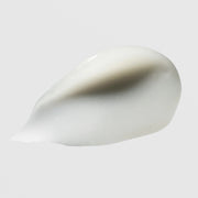 Hydrinity Restorative HA Serum texture swatch showing silky white hyaluronic acid serum formula on grey background.