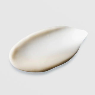 Hydrinity Vivid Brightening Serum texture swatch showing smooth creamy off-white brightening serum formula on grey background.