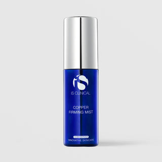 iS Clinical Copper Firming Mist cosmeceutical facial spray in a cobalt blue bottle with silver pump cap