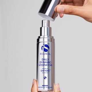Hands removing cap from iS Clinical Daily Dynamic Hydrator silver pump bottle powered by GeneXC technology