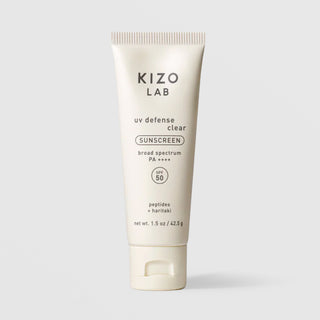 Kizo Lab UV Defense Clear Sunscreen SPF 50 broad spectrum PA++++ 1.5 oz cream tube with flip cap on grey background