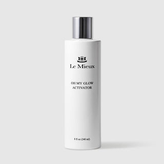 Le Mieux Oh My Glow Activator facial glow activator 8 fl oz 240 ml tall white bottle with silver cap. Available at Art of Skin Care