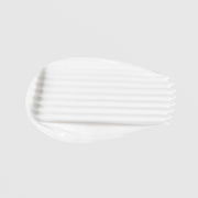 Le Mieux 24 Hour Age Defying Cream texture swatch showing rich thick white cream formula on grey background.