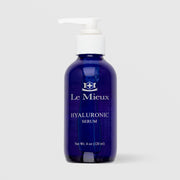 Le Mieux Hyaluronic Serum 4 oz 120ml in cobalt blue pump bottle on grey background.