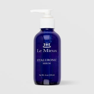 Le Mieux Hyaluronic Serum 4 oz 120ml in cobalt blue pump bottle on grey background.