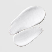 Le Mieux Microderm Exfoliant texture swatches showing creamy white exfoliating scrub formula with visible granules on grey background.