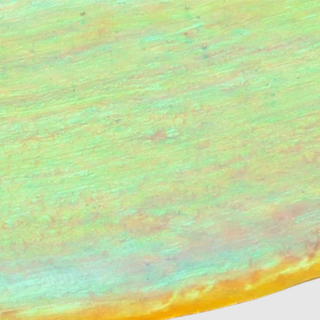 Le Mieux Eye and Lip Cream texture close-up showing iridescent pearl finish with green and gold shimmer.