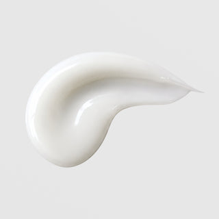 Michele Corley Clarifying Moisturizer texture swatch showing smooth glossy white cream formula on grey background.