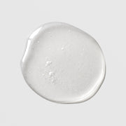 Michele Corley Mandelic Niacinamide Serum Plus texture swatch showing lightweight clear gel serum with fine bubbles on grey background.
