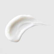 Michele Corley Purifying Oxygen Lotion texture swatch showing lightweight glossy white lotion formula on grey background.