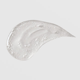 Michele Corley Ultimate Hydration Gel texture swatch showing lightweight clear gel formula with air bubbles on grey background.