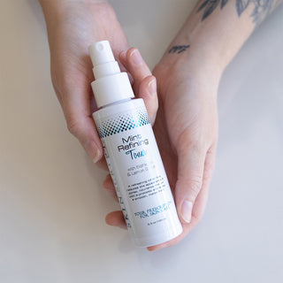 Mint Refining Toner resting in someone's hands.