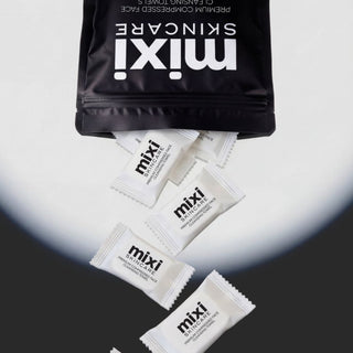 Mixi Skincare Premium Compressed Face Cleansing Towels spilling from resealable black pouch