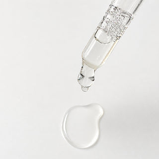 Mixi Dew Drops Hydrating Serum texture showing ultra-lightweight clear serum drop from glass dropper on white background.