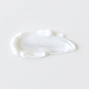 Mixi Hydroxi Acne Cream texture swatch showing lightweight white acne treatment cream formula on grey background.