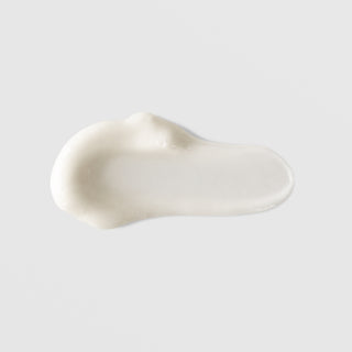 Mixi Mixilite Daily Moisturizing Cream texture swatch showing smooth glossy white cream formula on grey background.